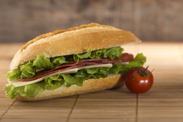 Sandwich with salami, cheese and lettuce