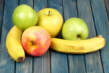 Bananas and apples on a wooden table