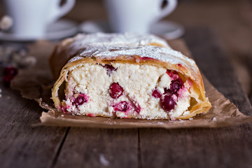 Strudel or pie with cranberries and cheese and two cups of coffee