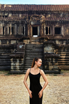 Cambodia Tourist Attraction. Happy Free Religious Young Woman Enjoying Life Outdoors At Prasat Angkor Khmer Wat Temple, Siem Reap. Famous Landmark, Asia Travel Destination. Serenity, Happiness Concept