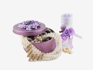 beautiful gorgeous golden earings in violet gemstone box,  aroma candle in glass decorated with artificial flowers and linen sack. on white background.