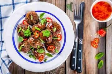 homemade meatballs with mint, green onions and chili sauce