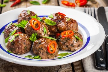 homemade meatballs with mint, green onions and chili sauce