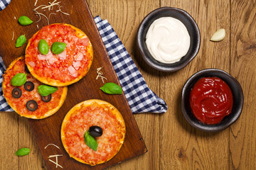 Mix of mini pizzas on wooden board