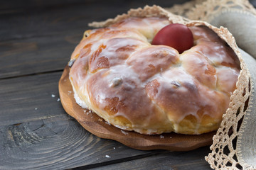 Easter bread with egg on wooden table, rustic style, selective focus