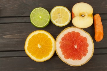 Fototapeta na wymiar Healthy fruit for diet. Fresh fruit on dark wooden board. A healthy diet with vitamins. 