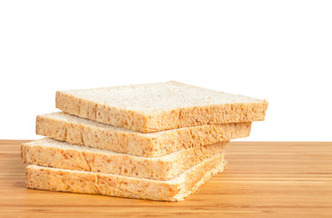 Bread, whole wheat slice on wooden table isolated in white backg