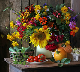 Still life with flowers and vegetables in a rustic style.