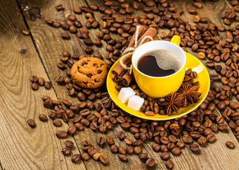 Coffee cup and coffee beans on table