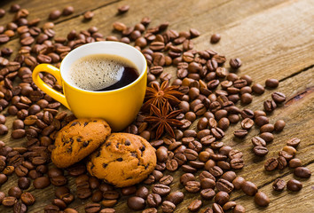 Coffee cup and saucer on a wooden table. Dark background, coffee