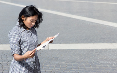 woman studying a city map at square