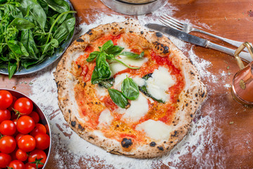 Traditional italian pizza with mozzarella, tomato and basil, on