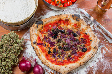 Traditional italian pizza with tuna, onions, caper and olives, o