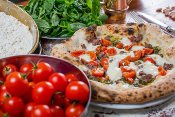Italian traditional pizza with mozzarella, sausage, tomato and p