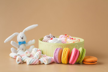 Gift Box of cupcakes and Colourful Macaron on beige Background,