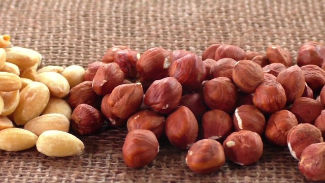 Almonds, cashew, walnuts and hazelnuts lying on burlap 
