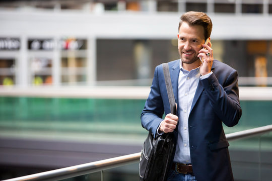 Young attractive business man using smartphone