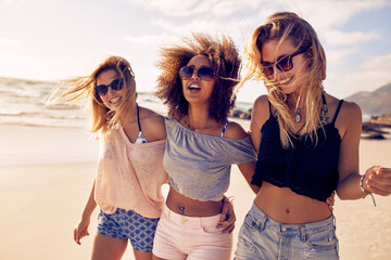 Group of beautiful young women strolling on a beach
