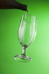 Beer pouring from bottle into glass