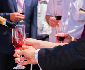 Wine is poured into a glass.