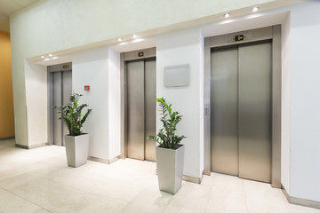 Three elevators in hotel lobby - obrazy, fototapety, plakaty