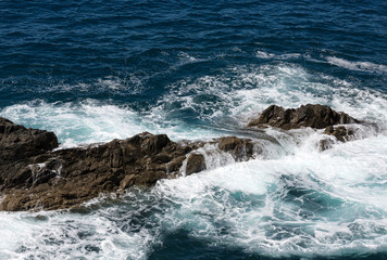 Wave splashing over a rock on Caleta Negra beach in Ajuy  on Fuerteventura. Canary Island, Spain
