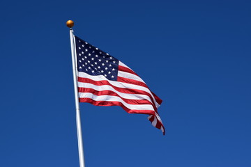 American flag waving in a clear blue sky
