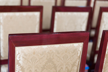 beige cushion with flower pattern decorating with wooden chair