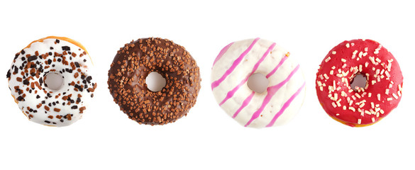 Four delicious donuts on a white background. Panorama. View from above.