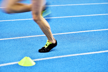 Blurred athlete feet on sprint track