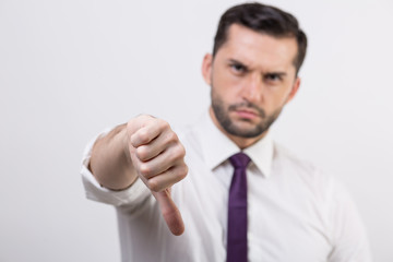 Young business man with thumb down