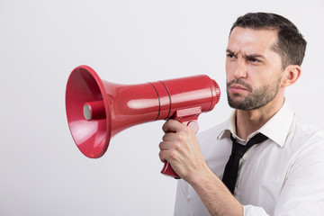 Business man holding a red loudspeaker
