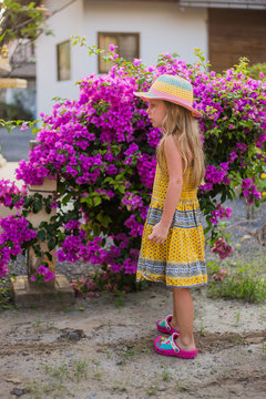 A girl stands at the beautiful flowering tree
