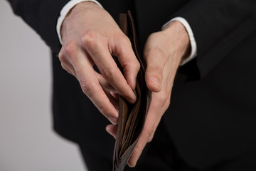 A businessman opens his leather wallet