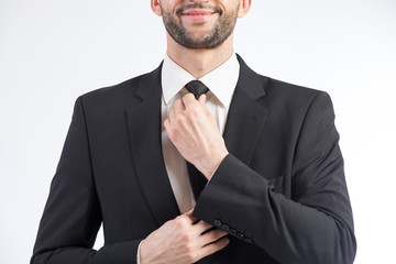 Man ties a necktie knot