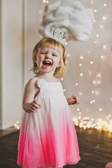 Happy child in a soft dress on the background lights 5429.