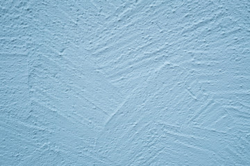Wand mit hellblauen Putz und Struktur