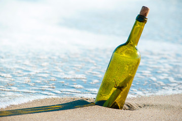 Message in a bottle on the beach seashore.
