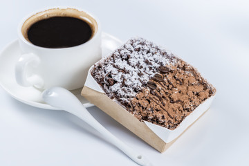 chocolate cake with coffee beans in the background cup of coffee