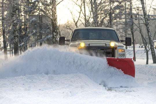 Snow plow doing snow removal after a blizzard