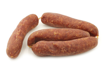 traditional Dutch smoked and dried sausages on a white background
