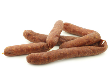 traditional Dutch smoked and dried sausages on a white background
