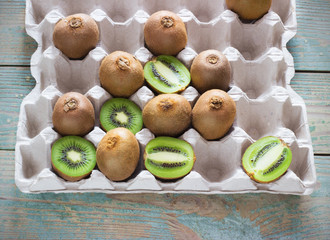 juicy kiwi in a tray on  wooden background