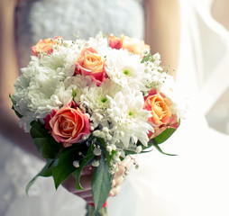 Beautiful bouquet of different colors in the hands of the bride
