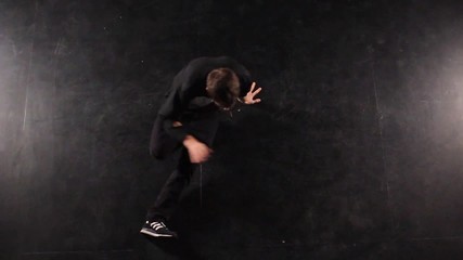 B-boy dancing breakdance in a photo studio on a black background.
