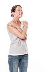 Fototapeta premium fun emotions - laughing young woman expressing delight, joy and wellbeing with comforting body language, white background studio.