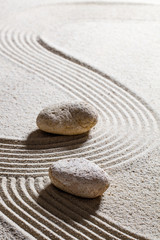 Fototapeta na wymiar zen sand still-life - two stones showing different directions for concept of evolution or progression with inner peace