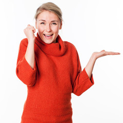 copy space display - laughing young woman holding something on an empty hand for presentation of product, white background studio.
