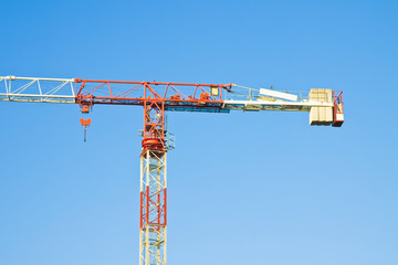 Tower crane in a blue background