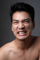 Obraz premium Asian man portrait with no makeup show his real skin in grey background - soft focus